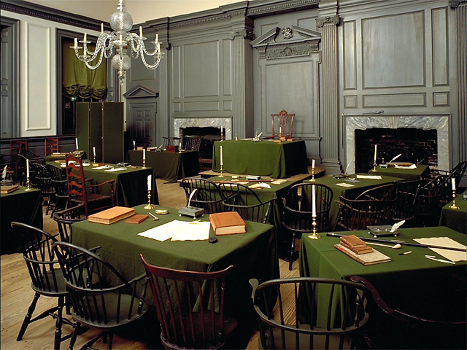 Tables and wooden chairs arranged in the Assembly Room of Independence Hall