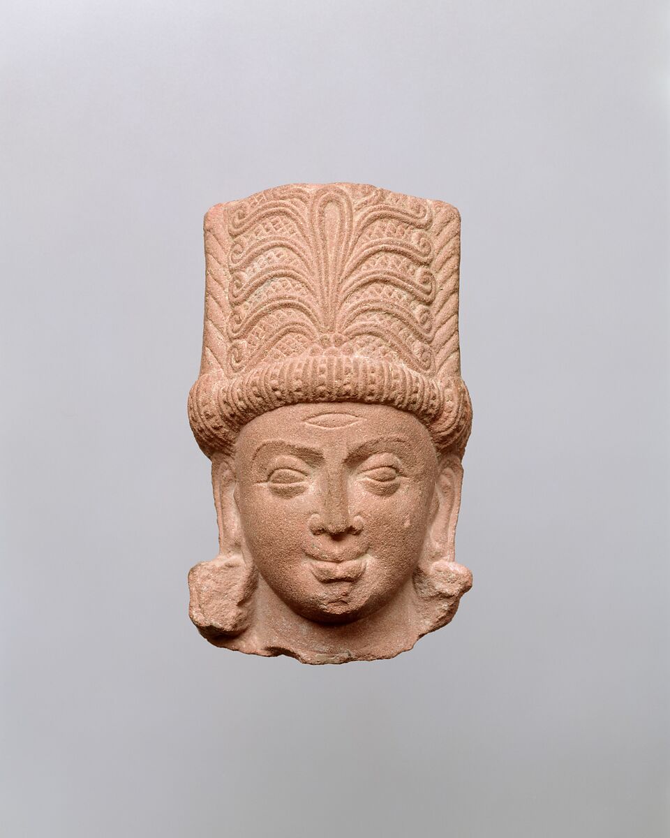 Sandstone head fragment of Indra wearing a tall, elaborately carved crown