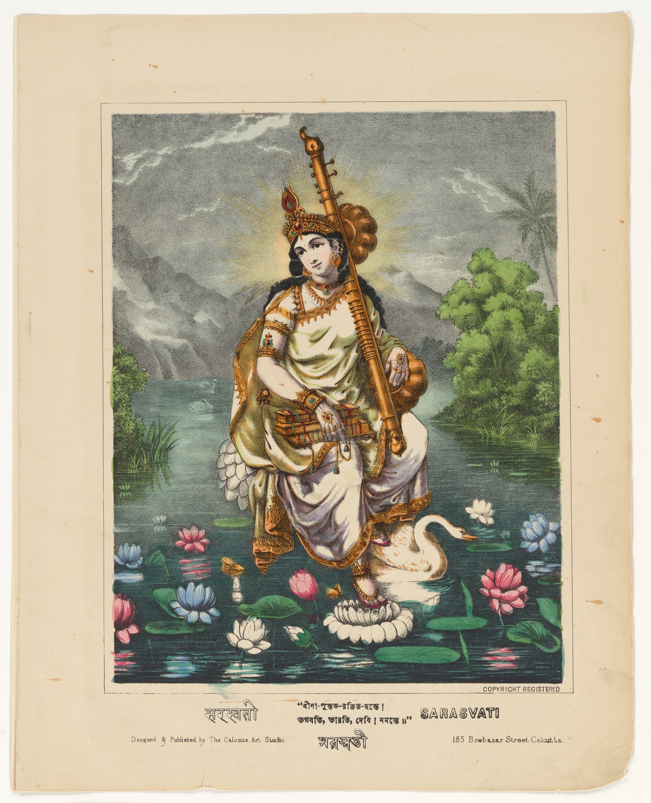 Sarasvati sits on a white lotus with a vina, palm-leaf books, and a white swan nearby